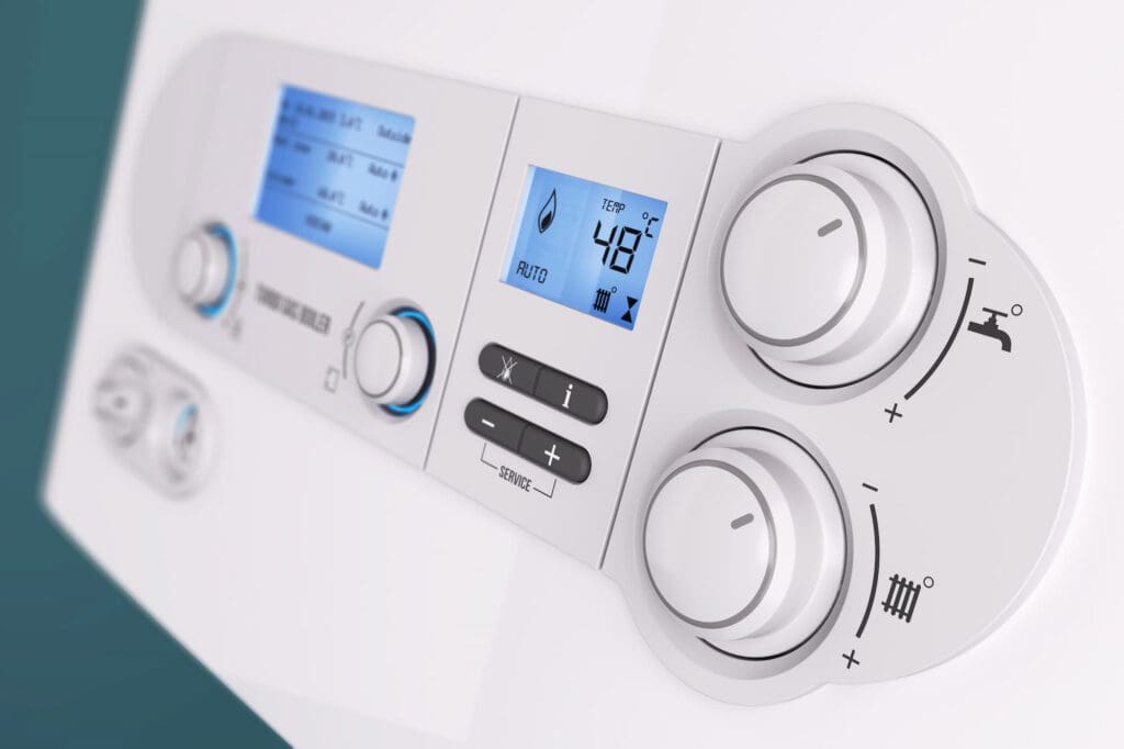 Close-up of a modern boiler control panel with two digital screens, buttons, and two dials displaying temperature settings and water heating functions. The screen shows a temperature of 48°C.